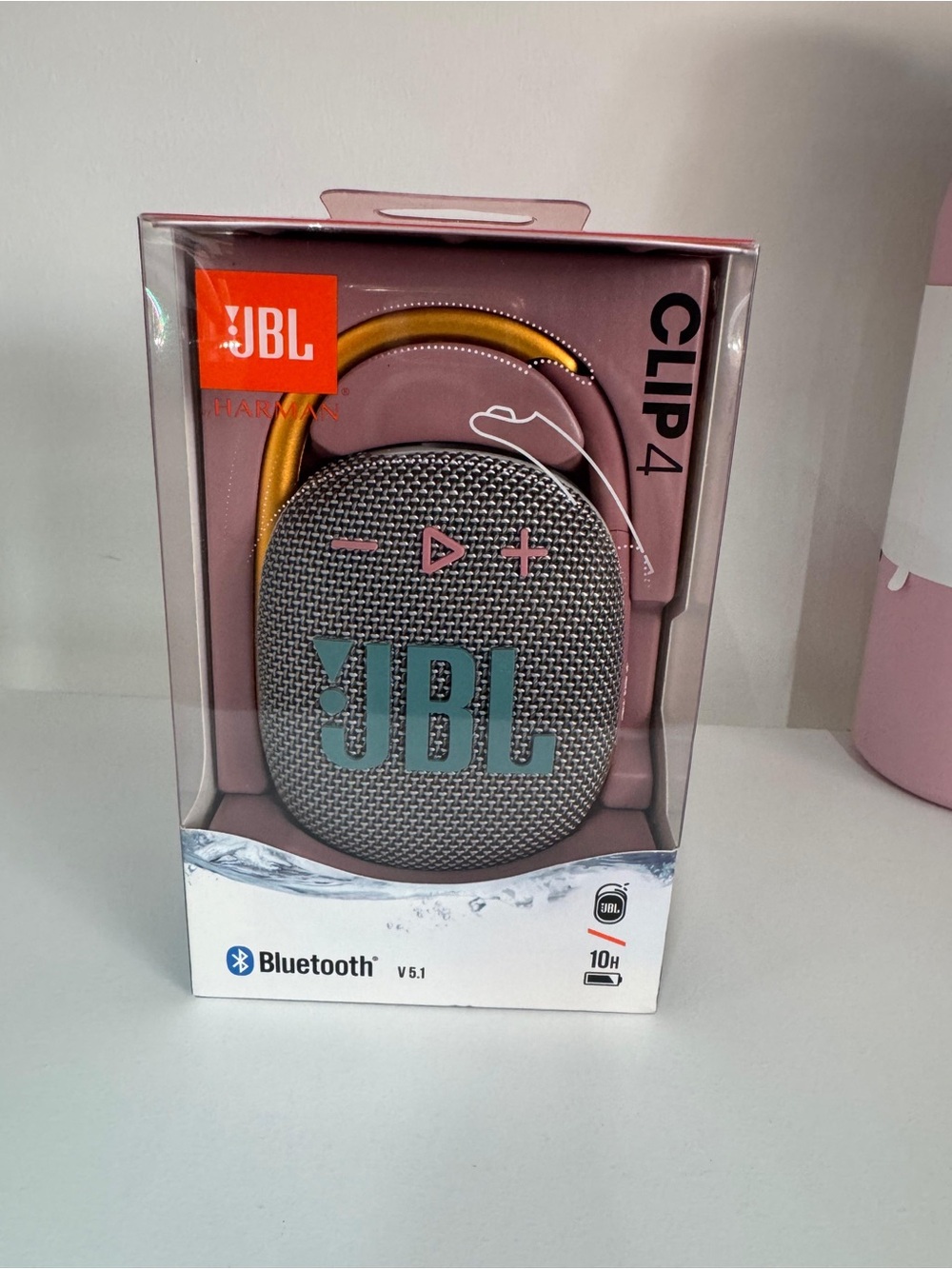 JBL Clip 4 Bluetooth Speaker in Gray with Teal Logo and Yellow Clip